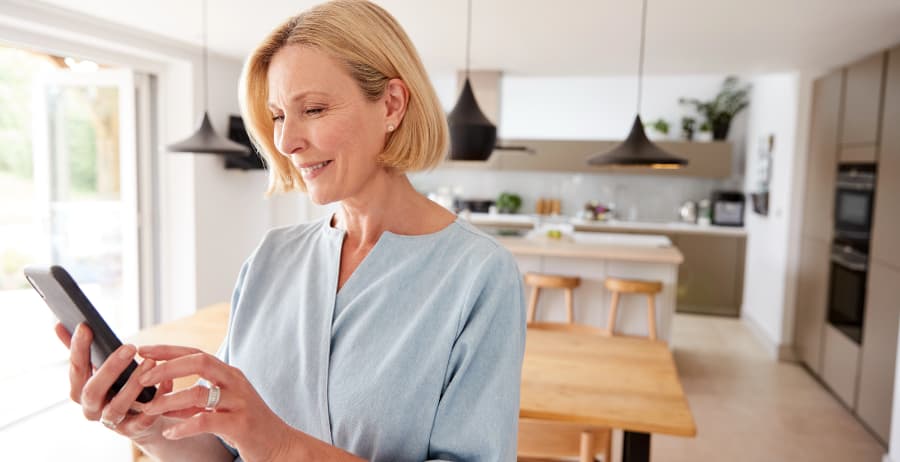 Resident holding a cell phone in a stylish home